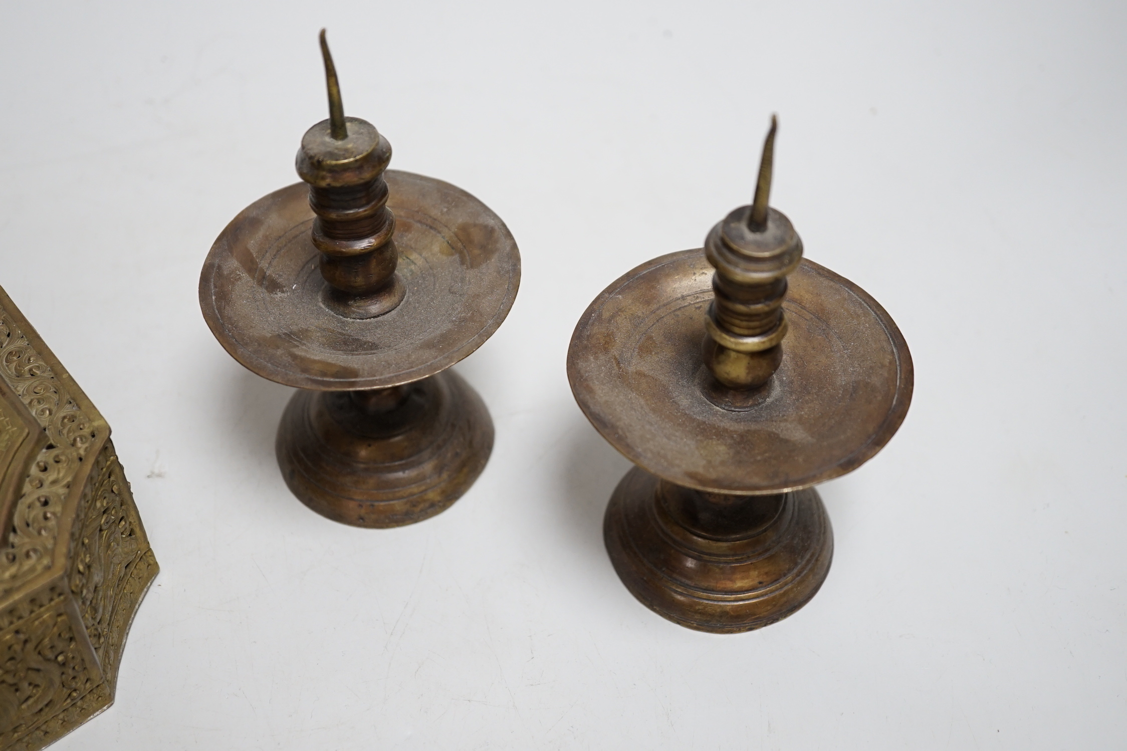 A pair of Middle Eastern bronze pricket candlesticks and an Indian pierced brass casket, candlesticks 14cm high